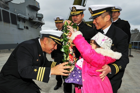 150129-N-ZZ999-014  BUSAN, Republic of Korea (Jan. 29, 2015) Cmdr. Joseph A. Torres Jr., commanding officer of the Arleigh Burke-class guided-missile destroyer USS Mustin (DDG 89), is greeted by the daughter of a Republic of Korea sailor as the ship arrives in Busan for a port visit. Mustin just concluded a series of bilateral training exercise with the Republic of Korea navy in international waters west of the Korean peninsula. The routine exercise focused on reinforcing teamwork and interoperability between the U.S. and Republic of Korea navies while giving Sailors the opportunity to sharpen their tactical skills. (U.S. Navy photo courtesy of Republic of Korea Navy/Released)