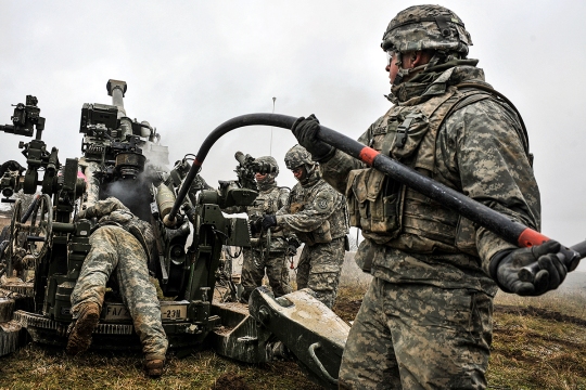 U.S. troopers, assigned to Bravo Battery, Field Artillery Squadron, 2nd Cavalry Regiment, load a M777 Howitzer during a live-fire exercise at the 7th Army Joint Multinational Training Command’s Grafenwoehr Training Area, Germany, Jan. 23, 2015. (U.S. Army photo by Visual Information Specialist Gertrud Zach/released)